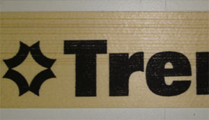 Advertising marking on a wooden box or profile.